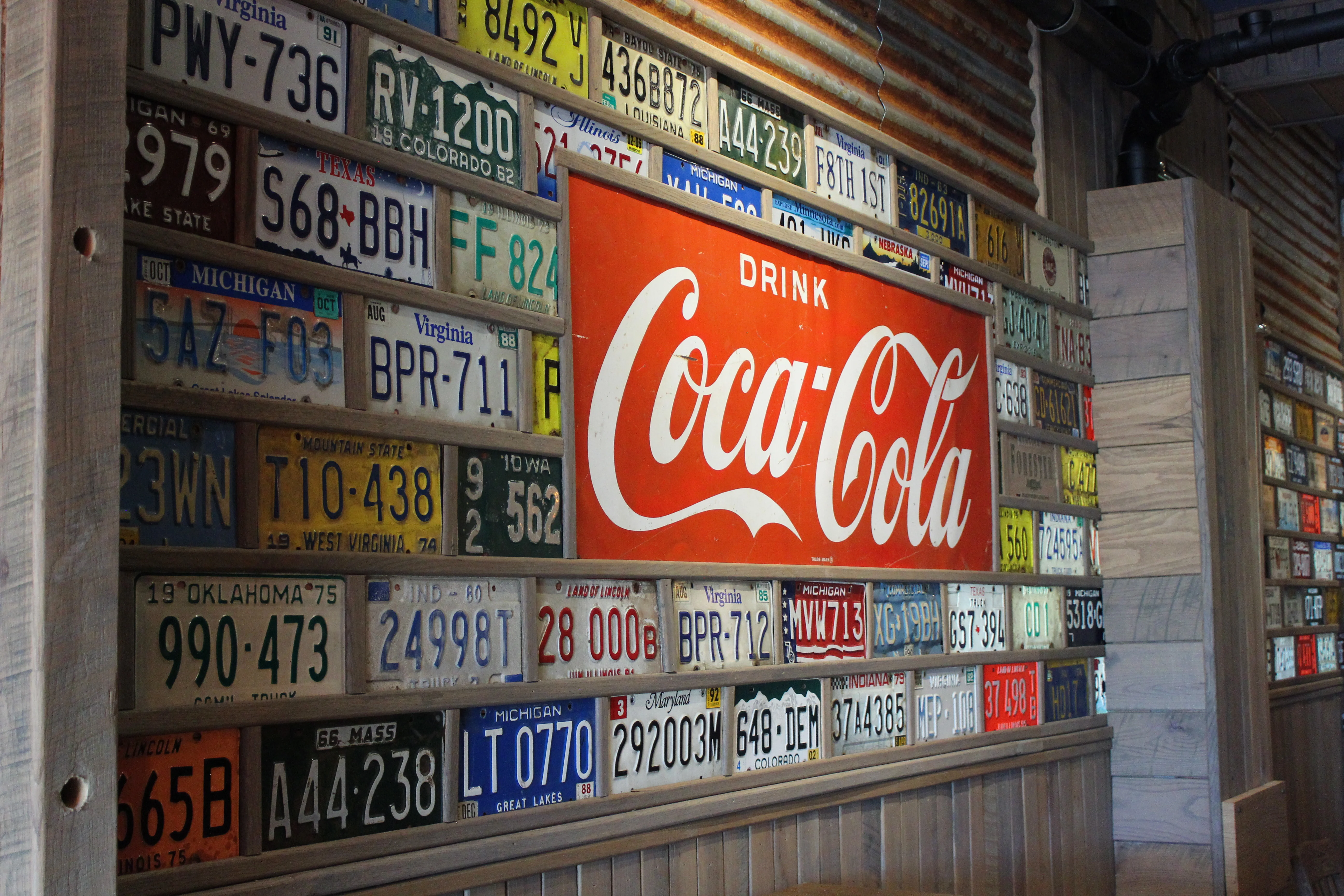 Vintage license plates and Coca-Cola sign in a restaurant interior