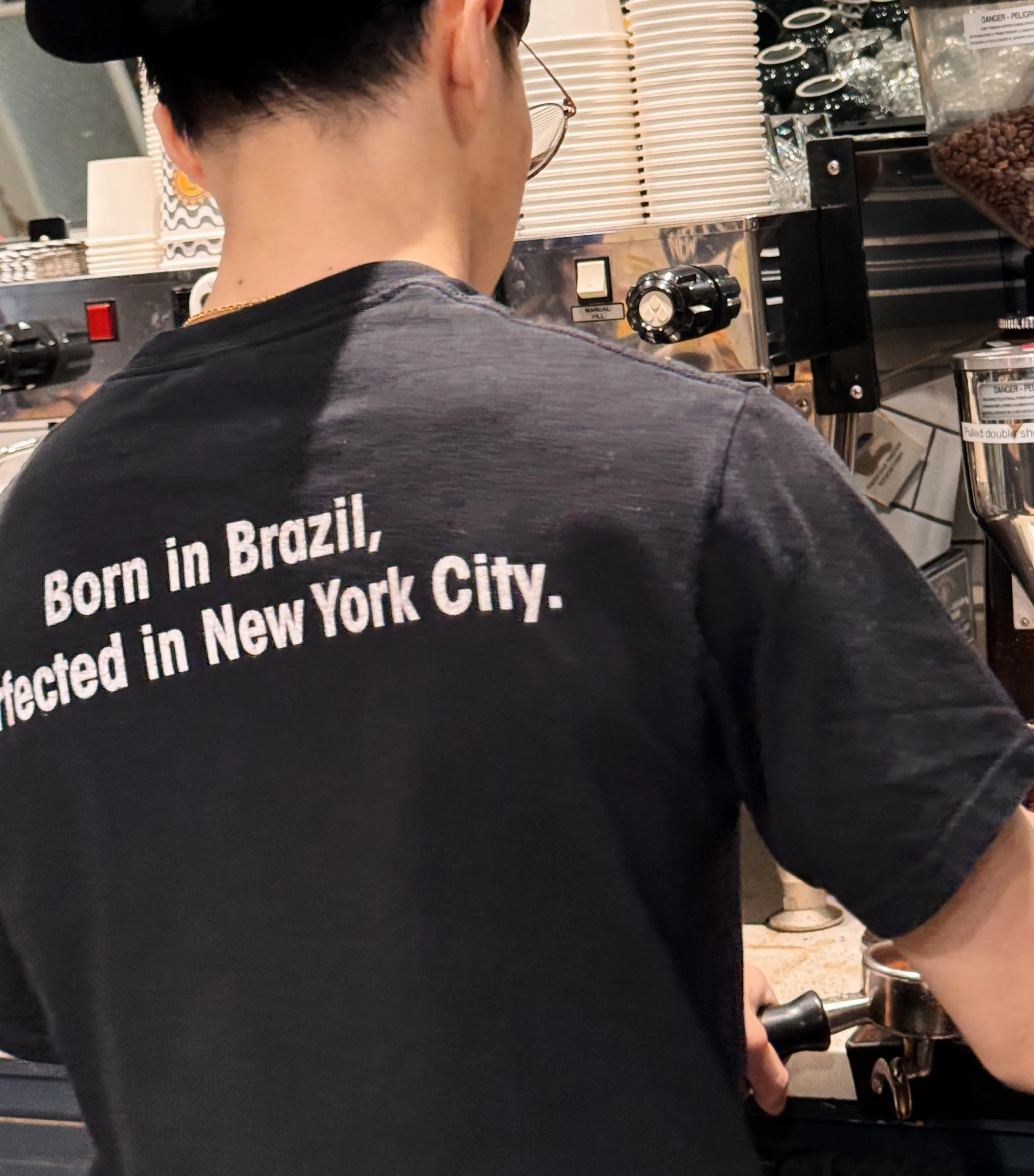 A smiling restaurant team member in a uniform, ready to serve customers.