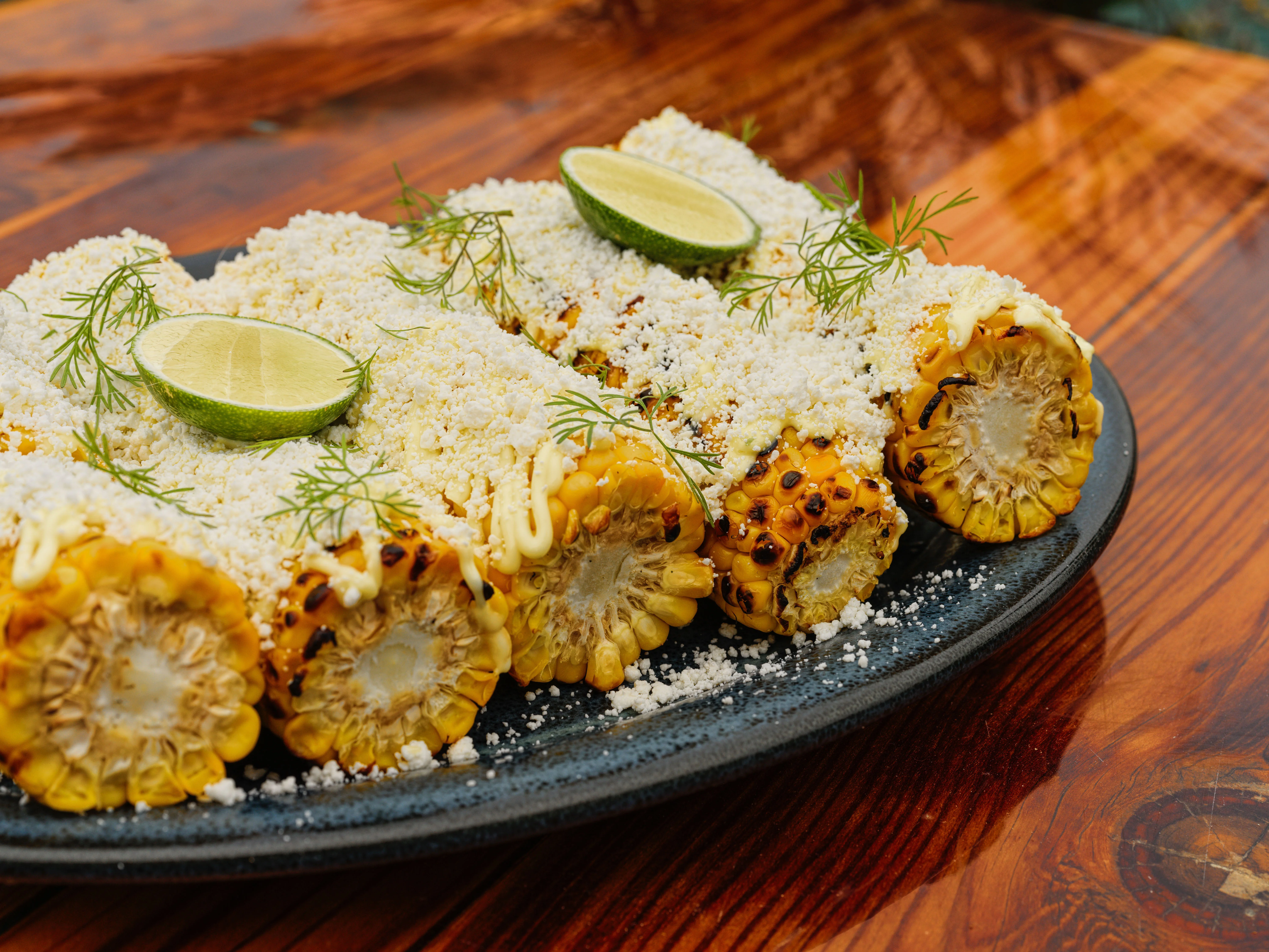 Mexican elote topped with cheese and lime