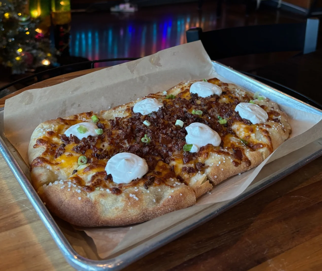 Savory flatbread topped with bacon and sour cream
