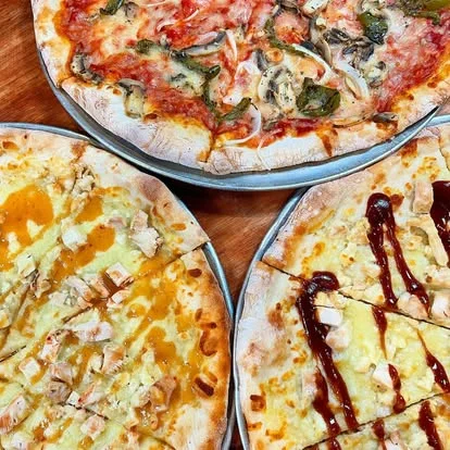 Assorted pizzas including BBQ chicken and classic Margherita