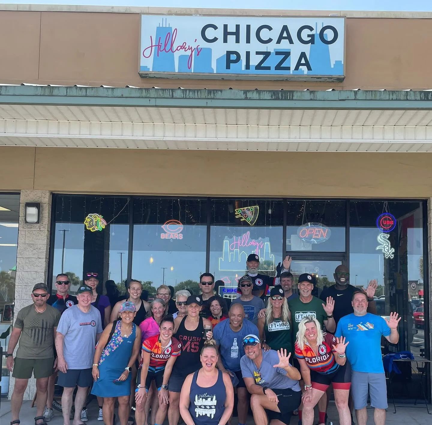 Group of friends celebrating outside Hillay's Chicago Pizza