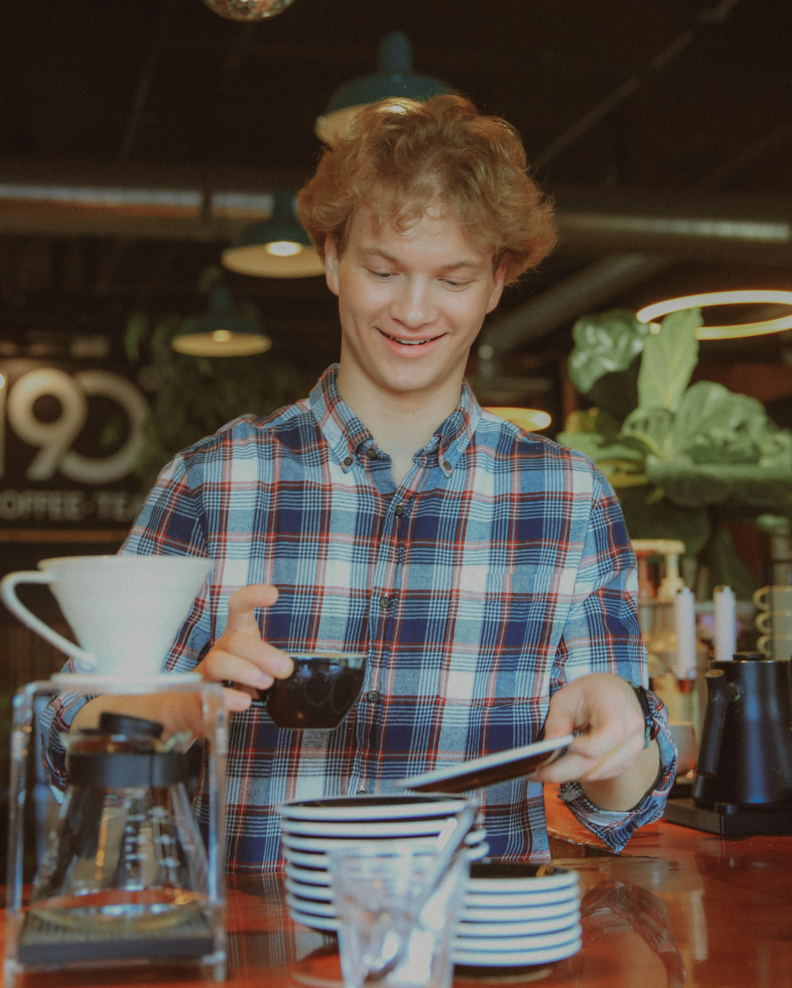 Barista preparing coffee in a modern café setting