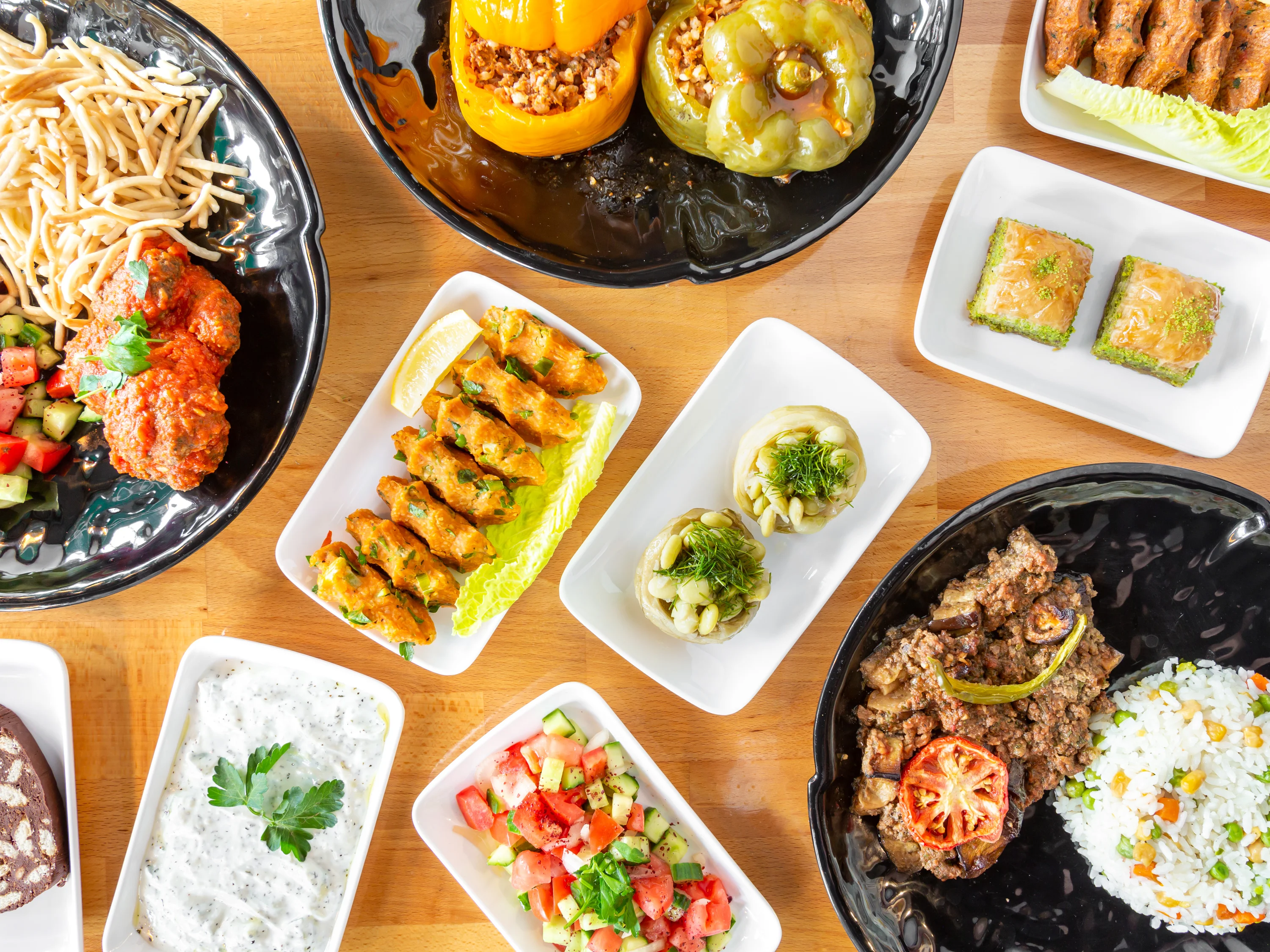 Assorted Middle Eastern dishes including kebabs and stuffed peppers
