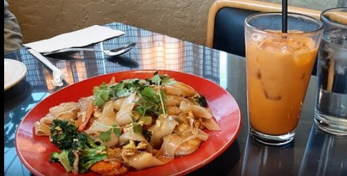 Plate of Thai pad see ew with shrimp and vegetables