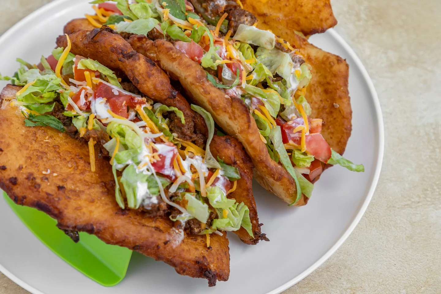 Crispy taco platter with seasoned beef and fresh toppings