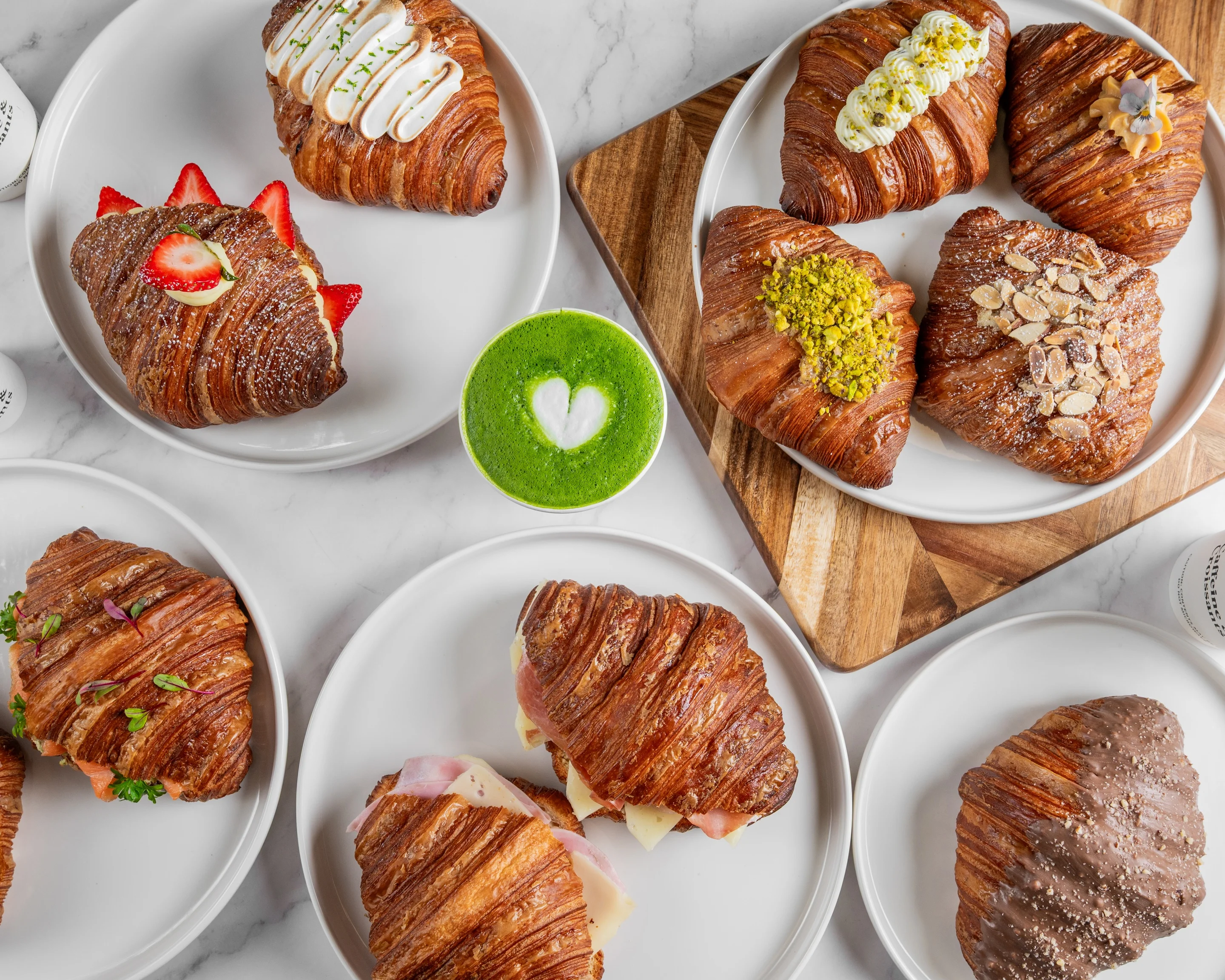 Assorted gourmet croissants with unique toppings and fillings