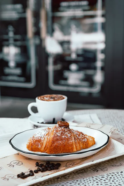 Freshly baked French croissant with coffee