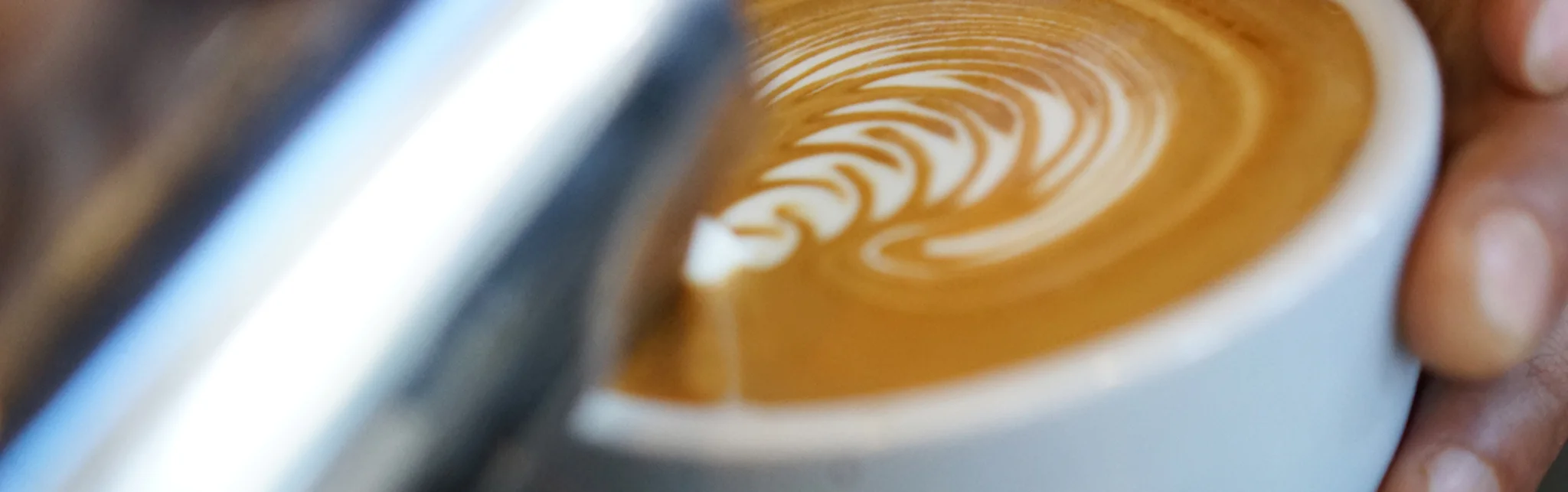 Artfully crafted latte with intricate foam design