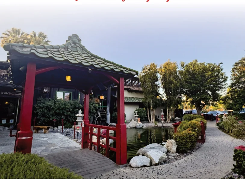 Serene Japanese garden with a red bridge and pond