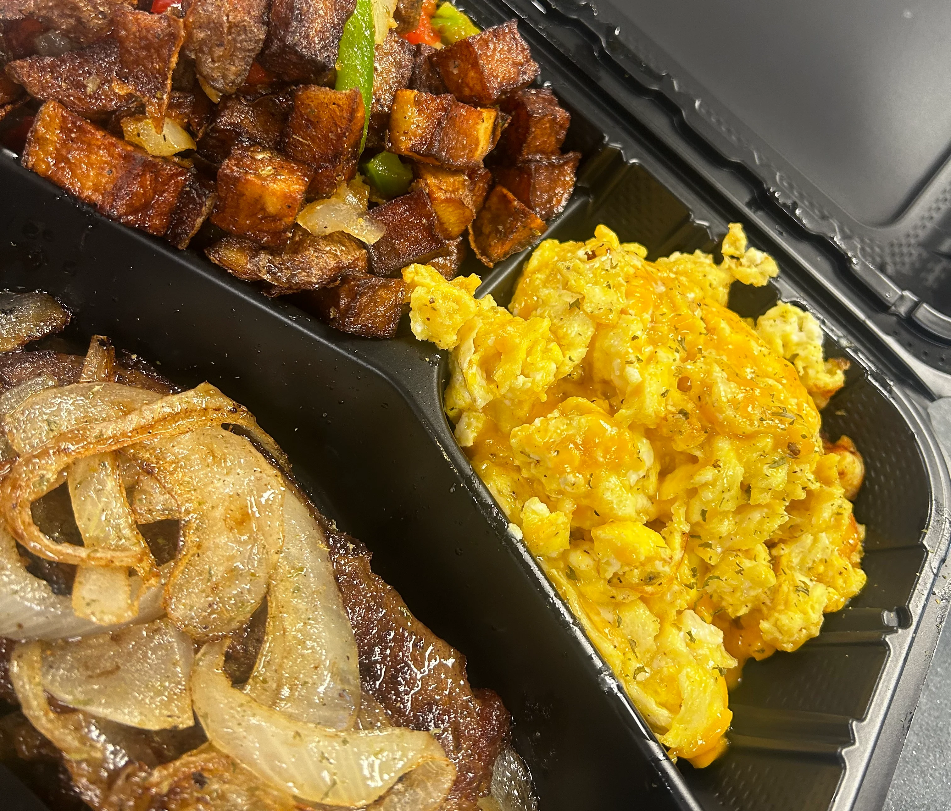Cuban breakfast platter with steak, eggs, and fried potatoes
