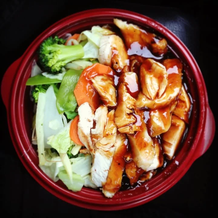 A plate of sushi rolls filled with eel and cucumber, served with pickled ginger and wasabi. The rolls are arranged neatly on a white plate.