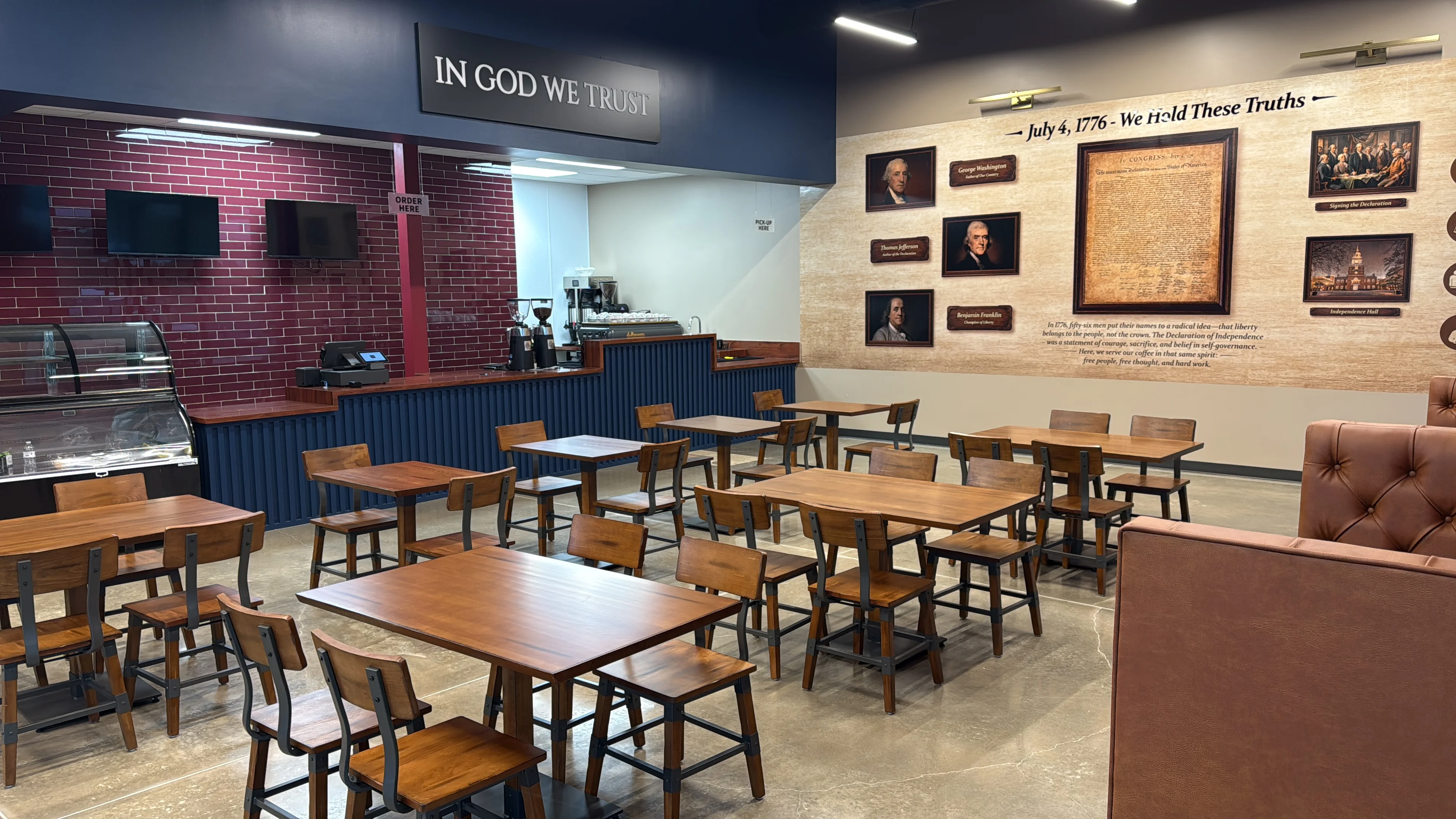 Interior of a restaurant with tables, coffee bar, and historical decor.