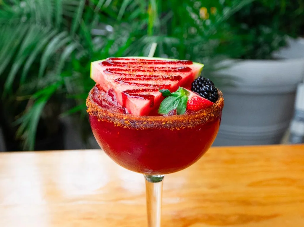 Colorful Mexican michelada cocktail with fresh fruit garnish