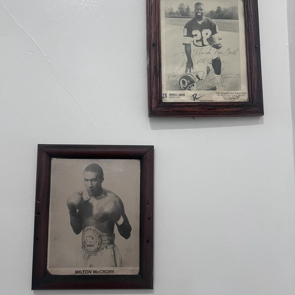 Framed black-and-white portraits and theater poster on a restaurant wall