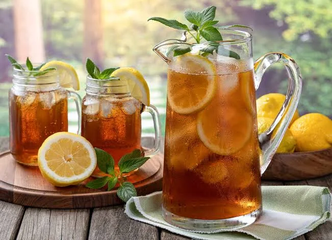 Refreshing iced tea with lemon and mint in a sunny outdoor setting