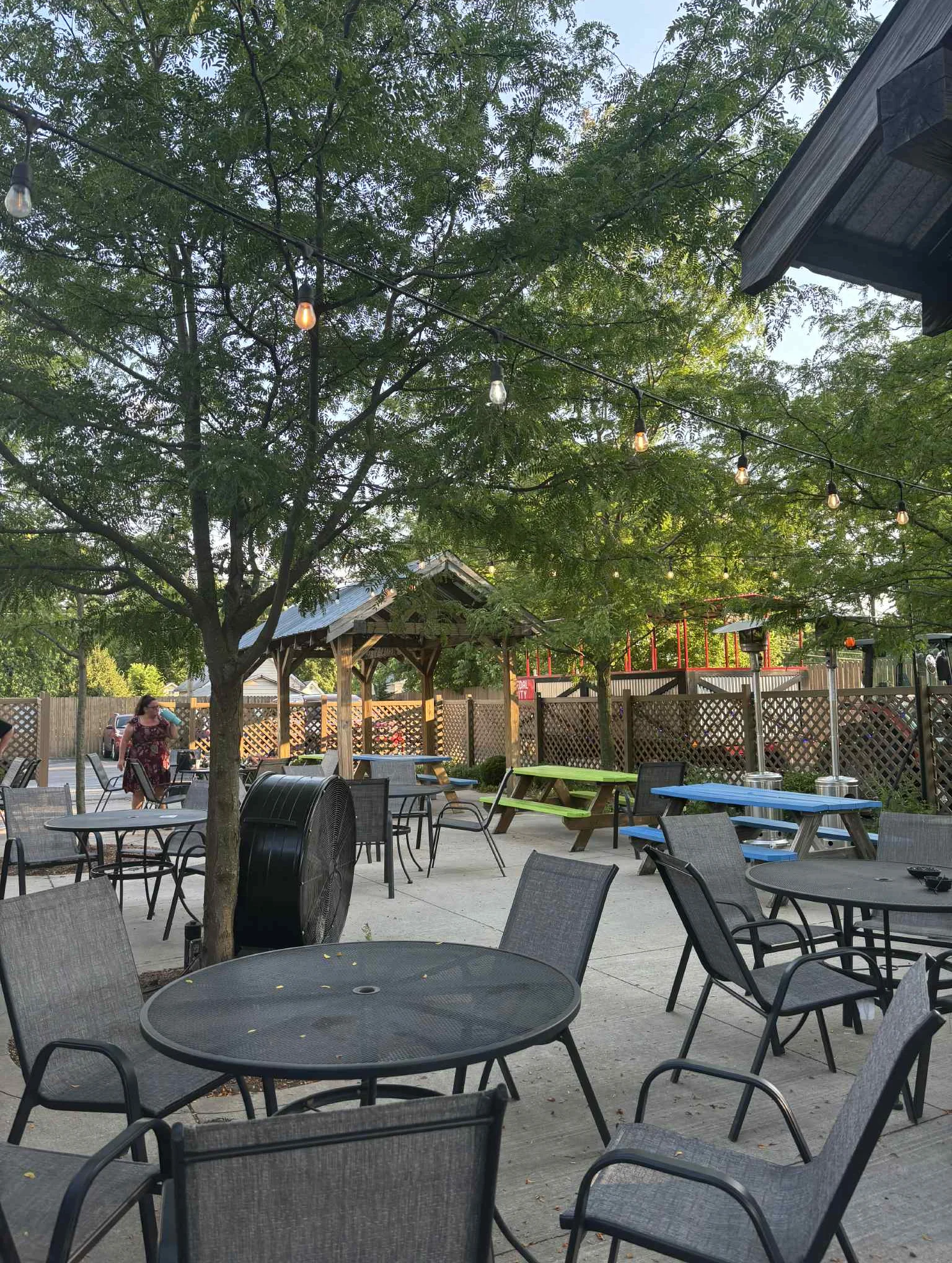 Outdoor dining area with string lights and shaded tables