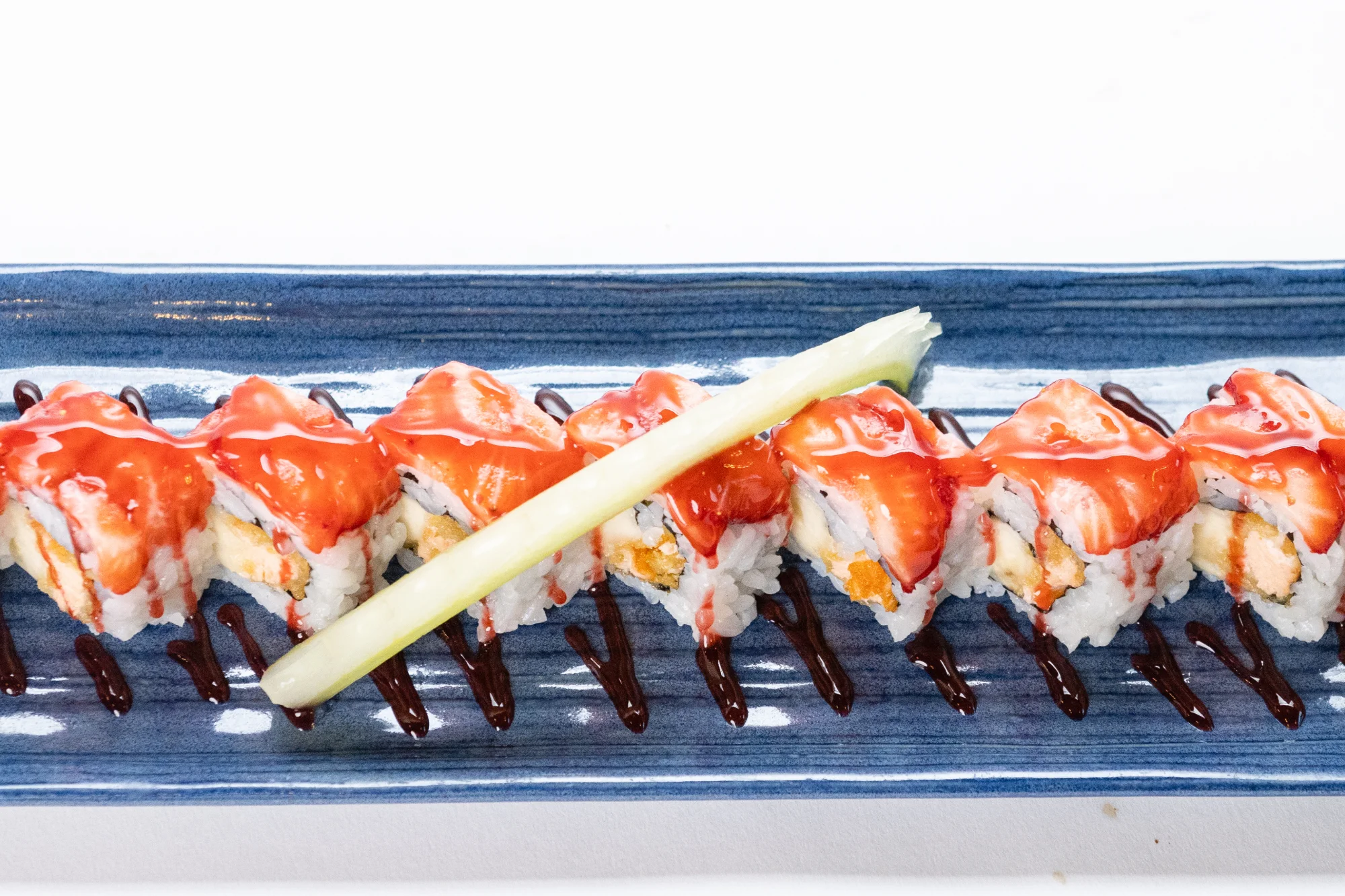 Japanese sushi roll with sweet sauce and garnish