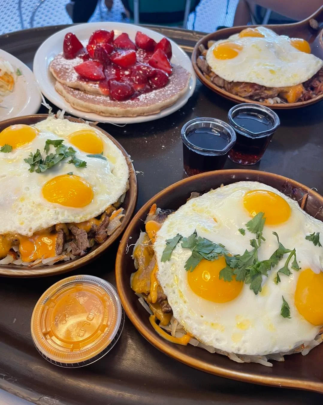 Hearty breakfast platters with eggs and pancakes