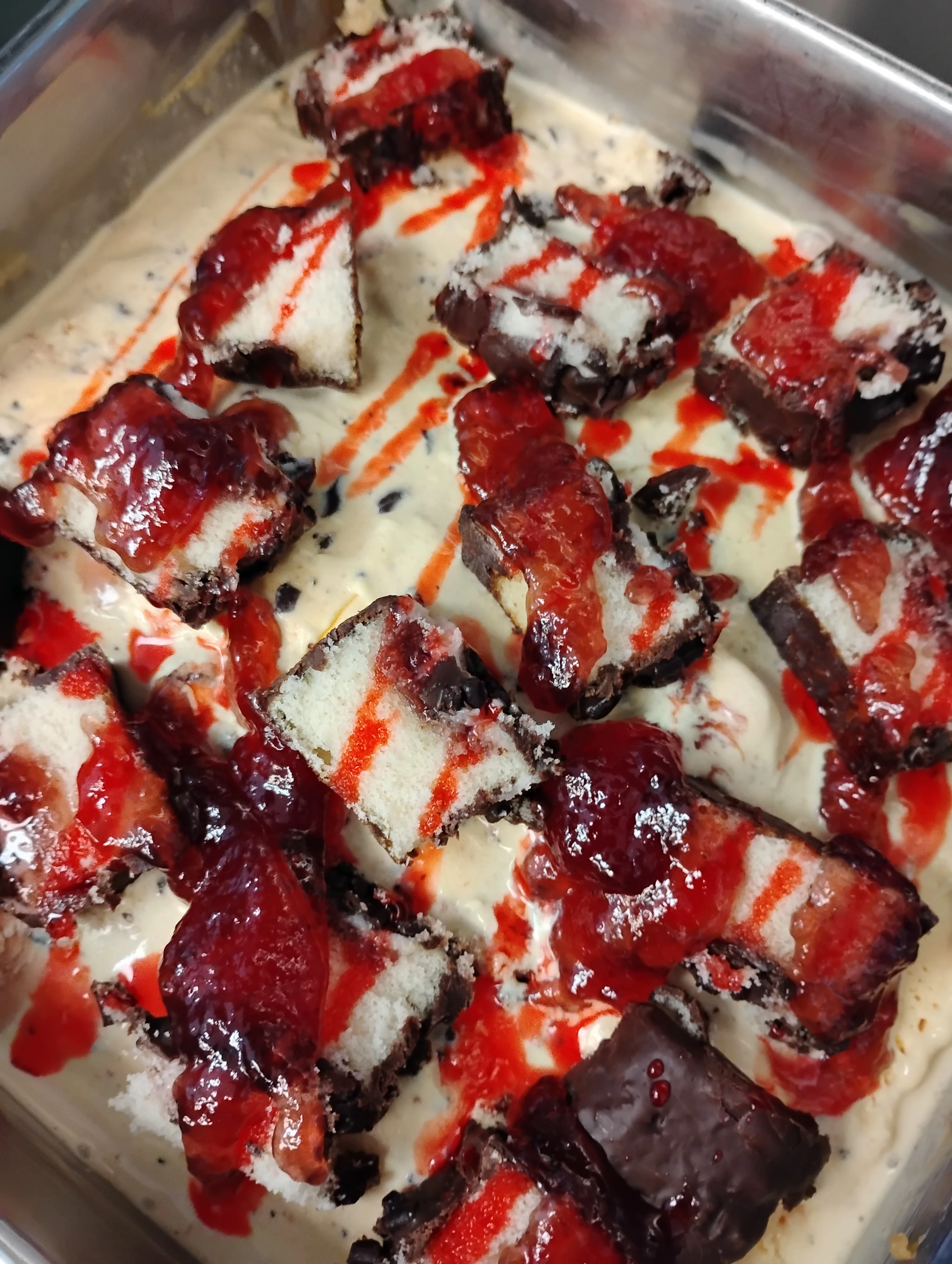 Decadent dessert featuring chocolate cake and strawberry sauce