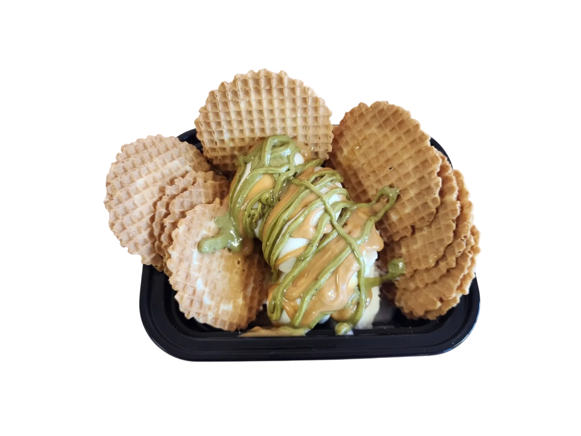 Waffle cone bowl filled with ice cream and drizzled with green sauce.