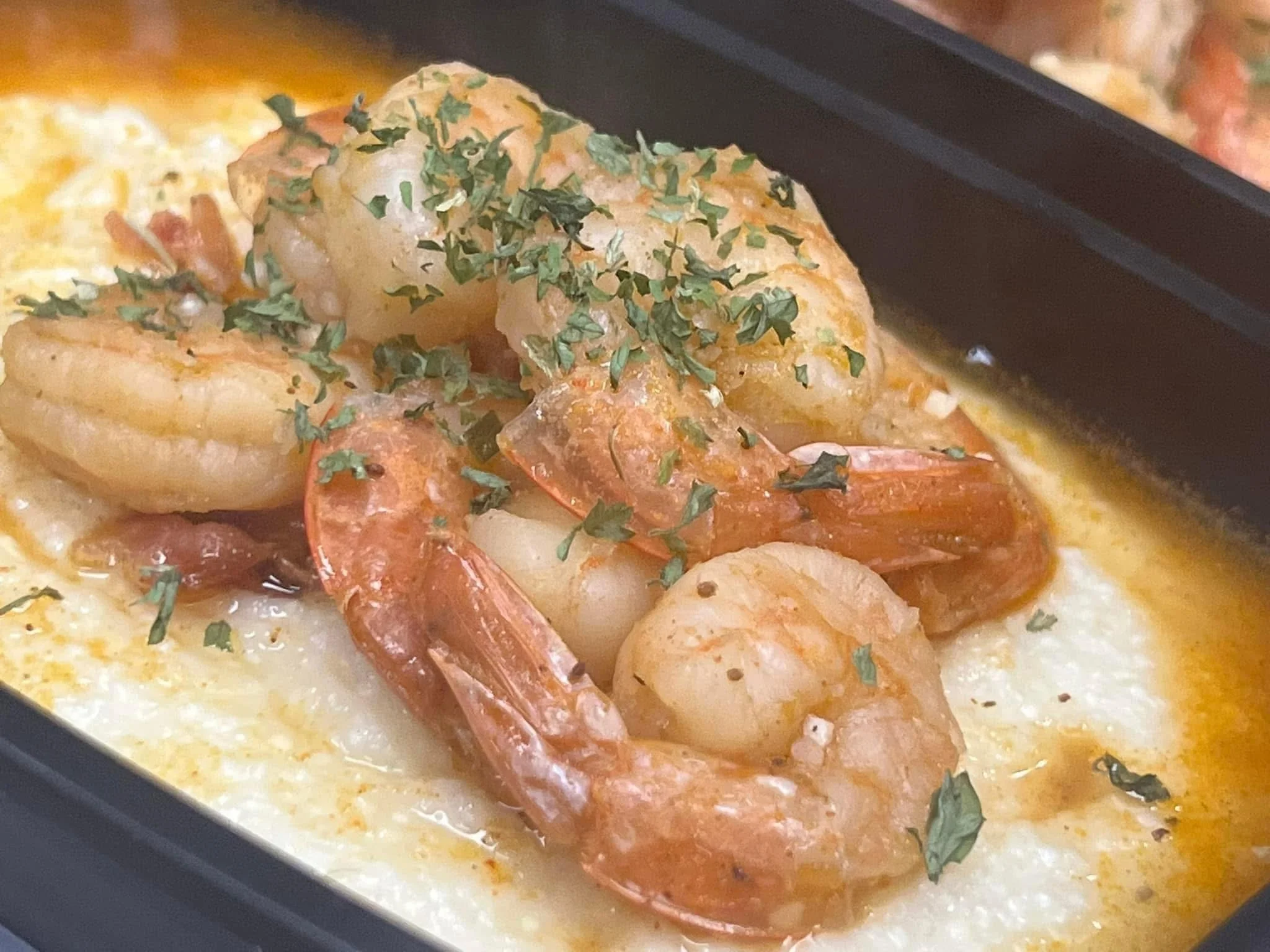 Shrimp and grits, a classic Southern dish with herbs