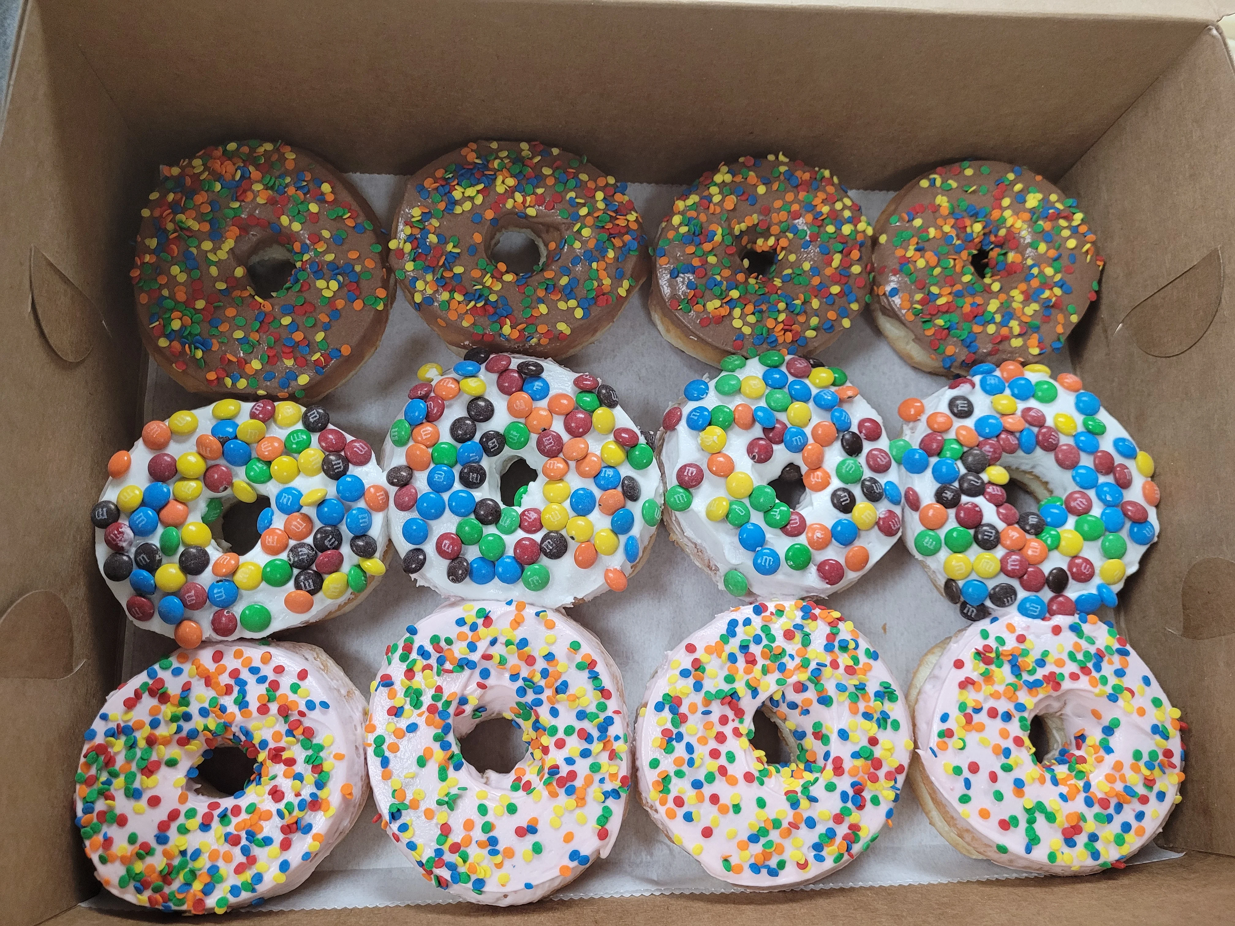Colorful assortment of decorated donuts in a box