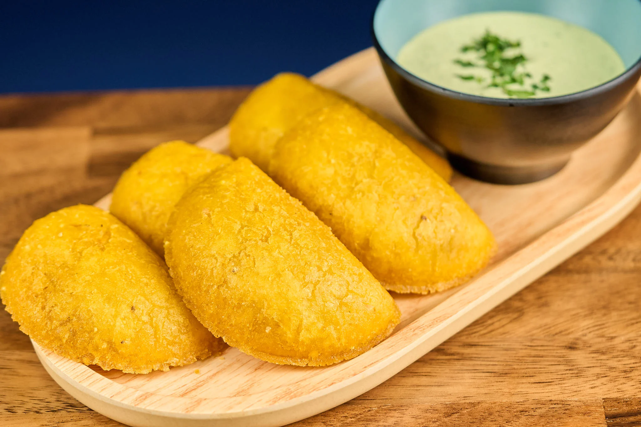 Crispy Colombian arepas with green sauce
