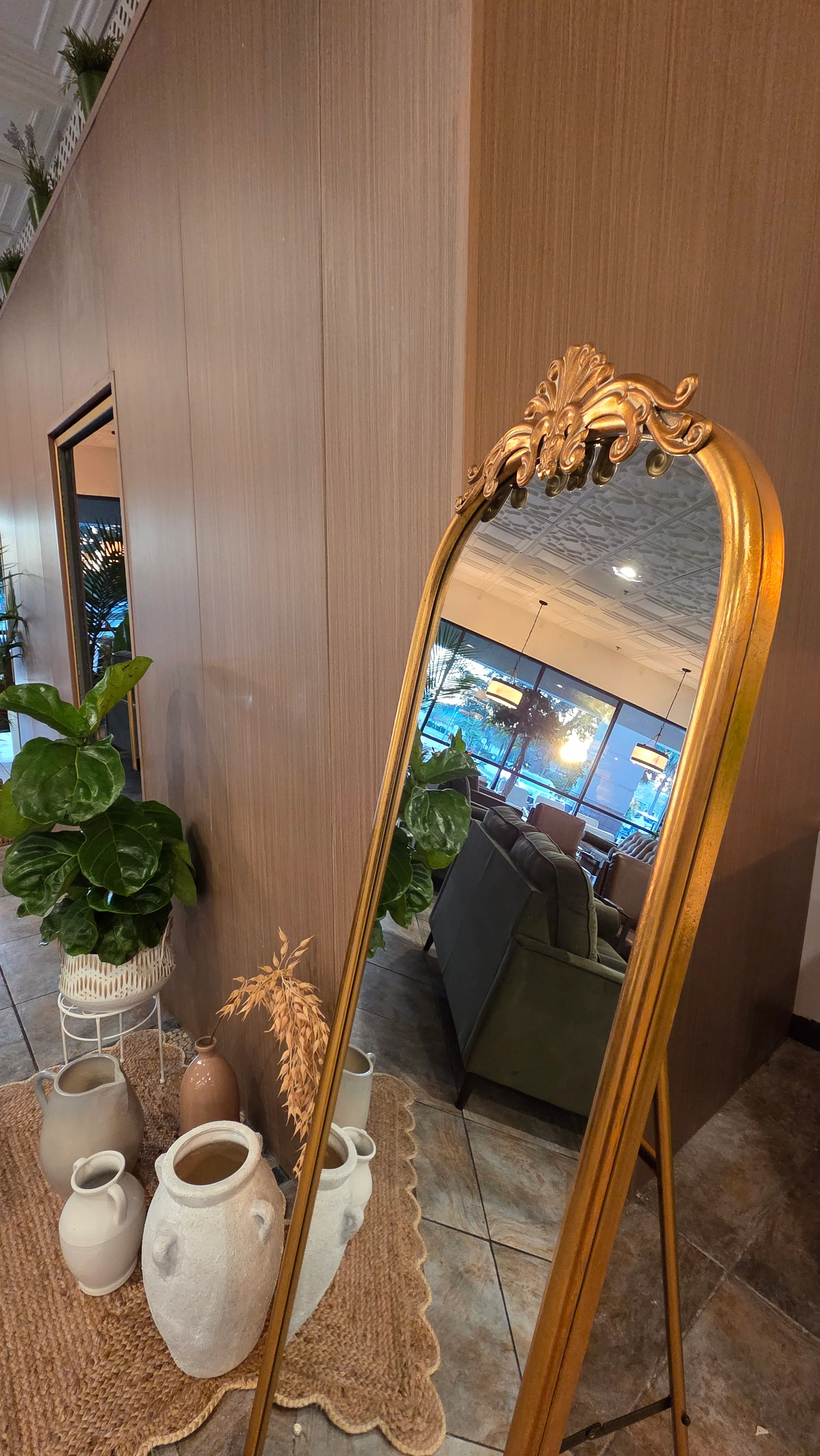 Elegant restaurant interior with vintage mirror and greenery