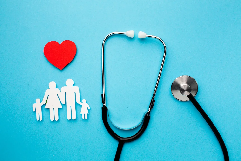 Stethoscope and family paper cutouts with a heart symbol