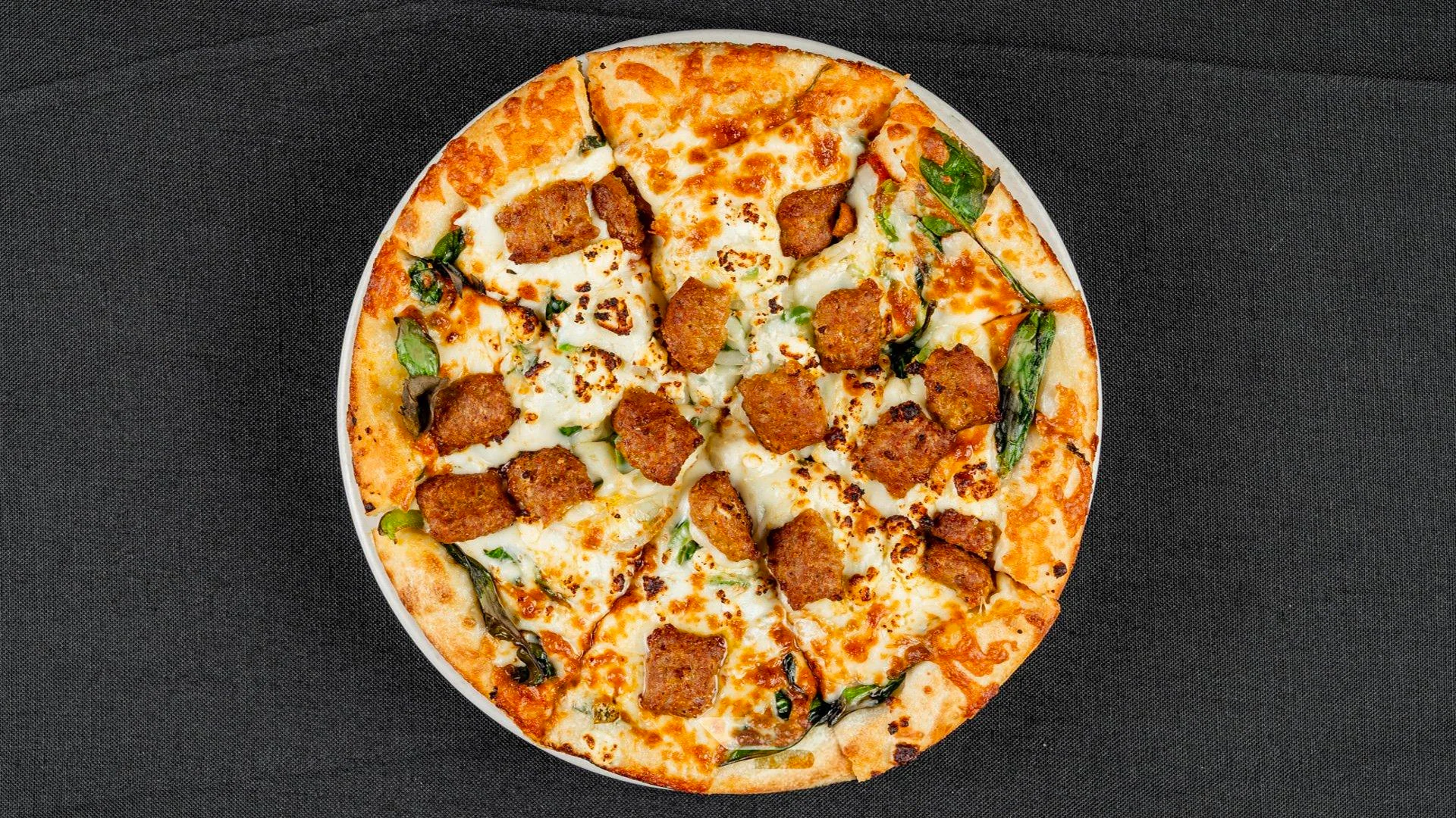 A delicious pizza with various toppings from Hubbs Pizzeria.