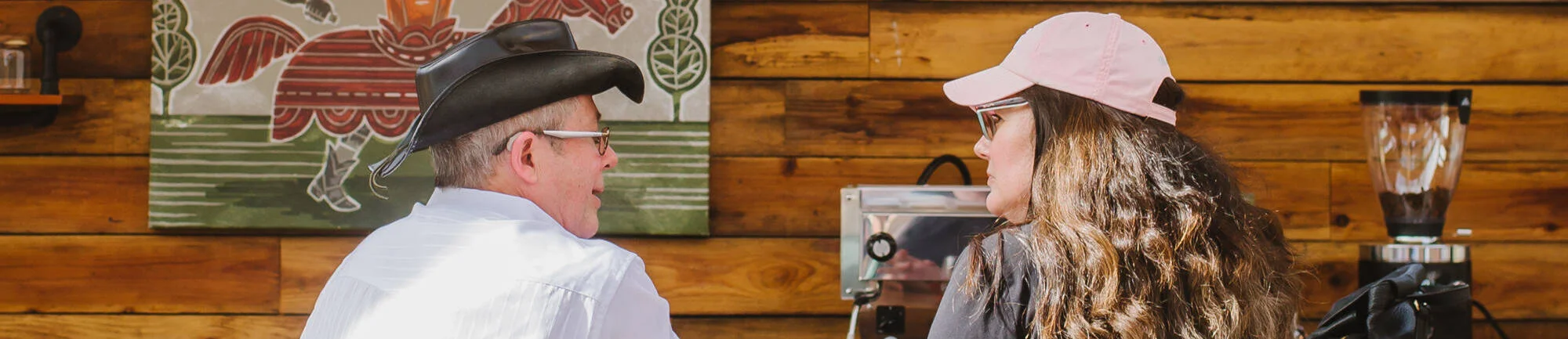 Two people enjoying coffee at a rustic café