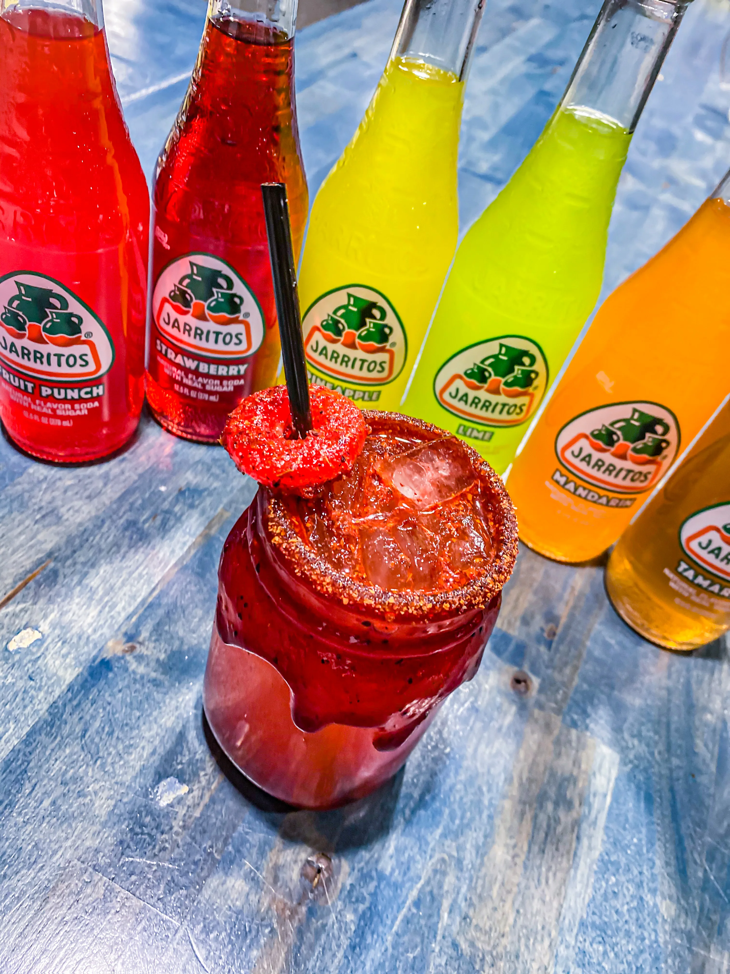 Colorful Mexican drink with Jarritos sodas and a cocktail garnish
