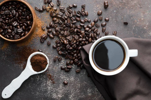Freshly brewed coffee with roasted beans and ground coffee