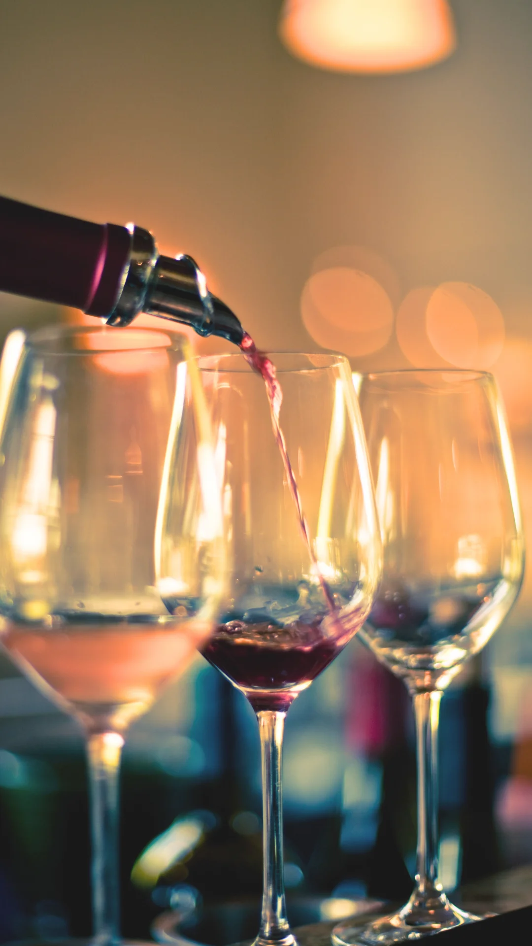 Pouring red wine into elegant glasses