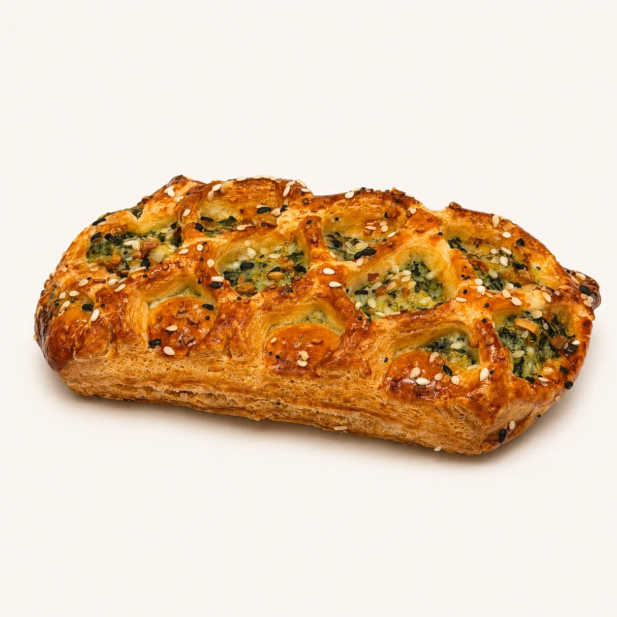 A savory pastry featuring a flaky crust with a filling and topped with seeds and herbs for flavor.