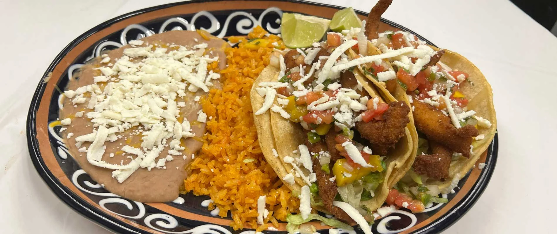 Delicious Mexican fish tacos with rice and beans