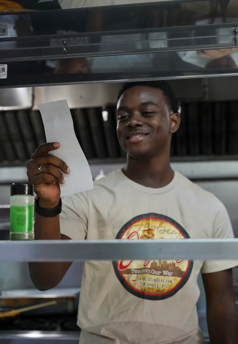 Chef reviewing an order in a busy kitchen