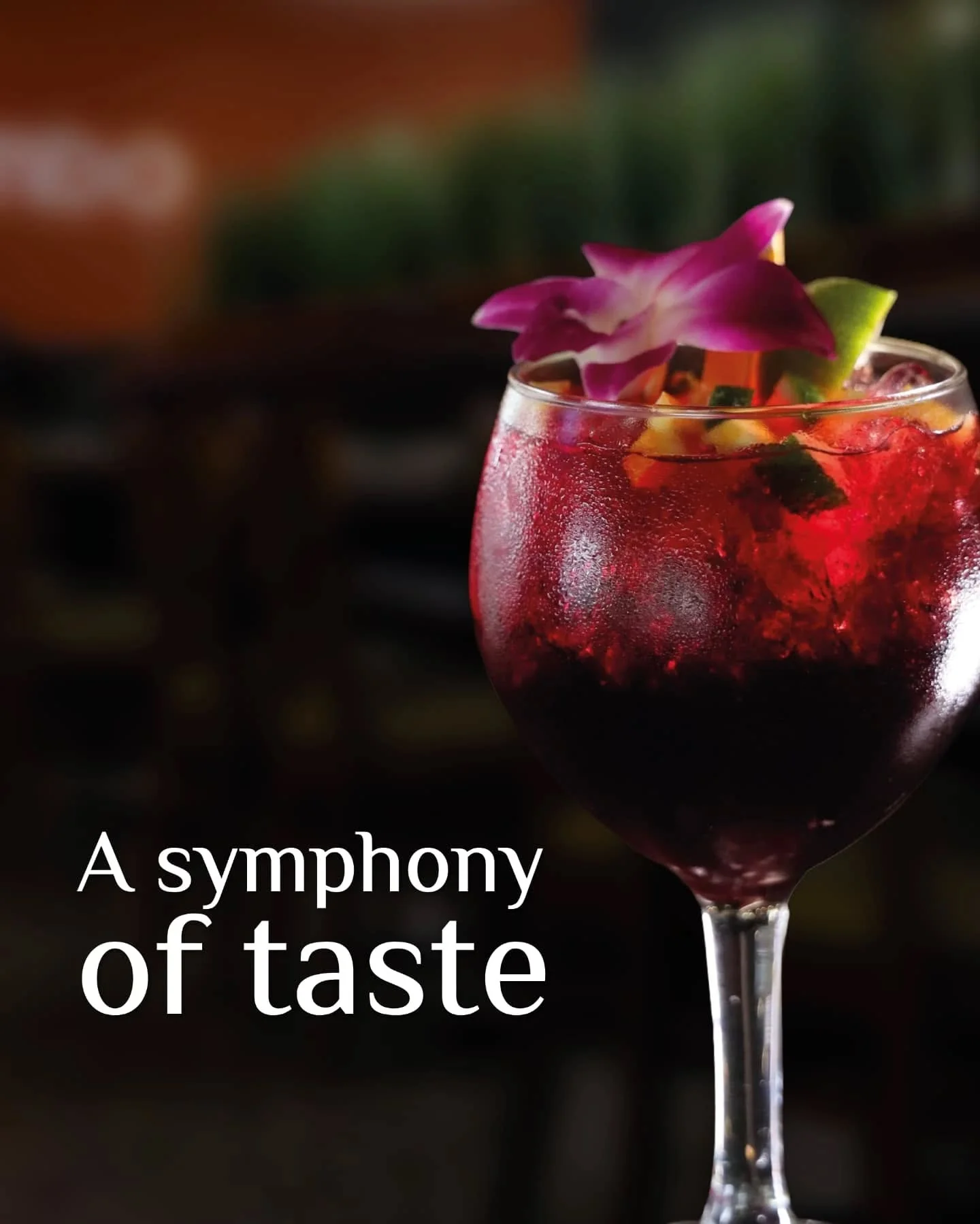 Colorful cocktail garnished with flowers and fruit