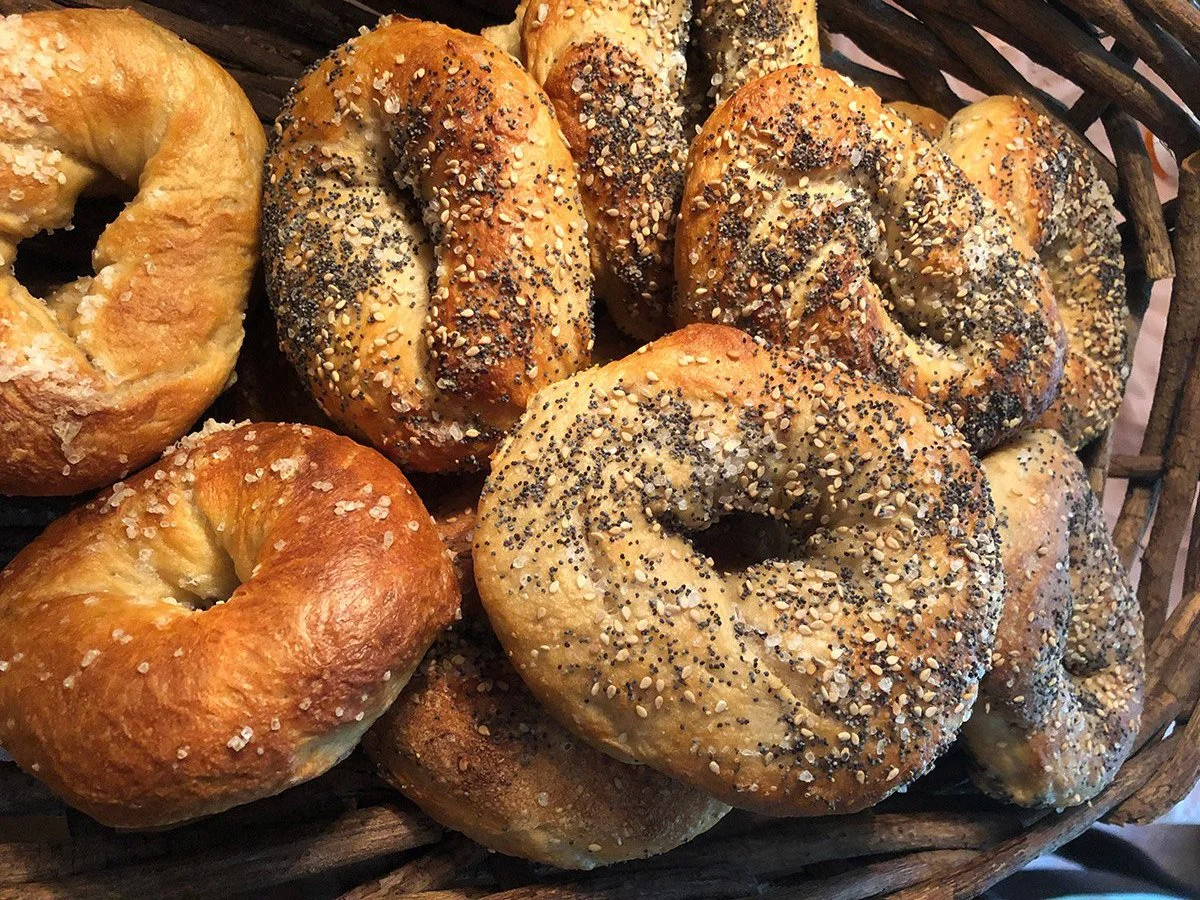 Freshly baked New York-style bagels in a woven basket