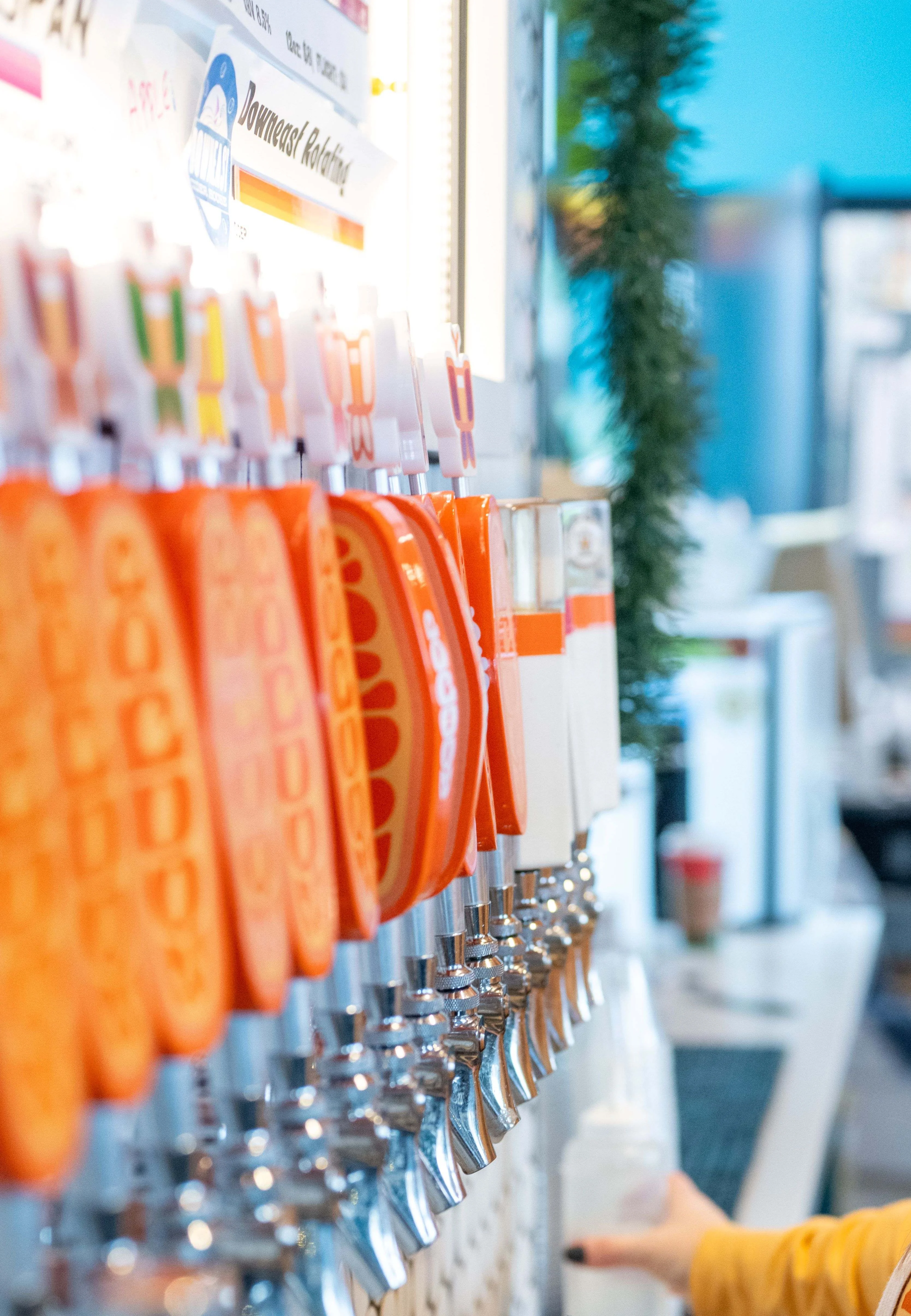 Staff member pouring craft beer at a tap station