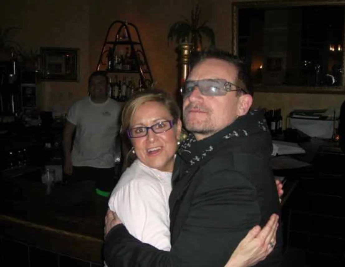 Two people posing happily at a bar counter