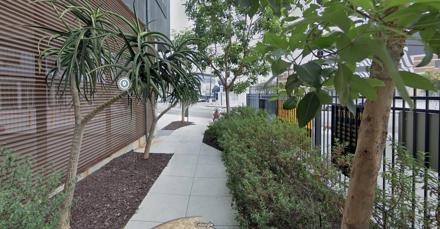Pathway lined with greenery and modern architecture in Los Angeles