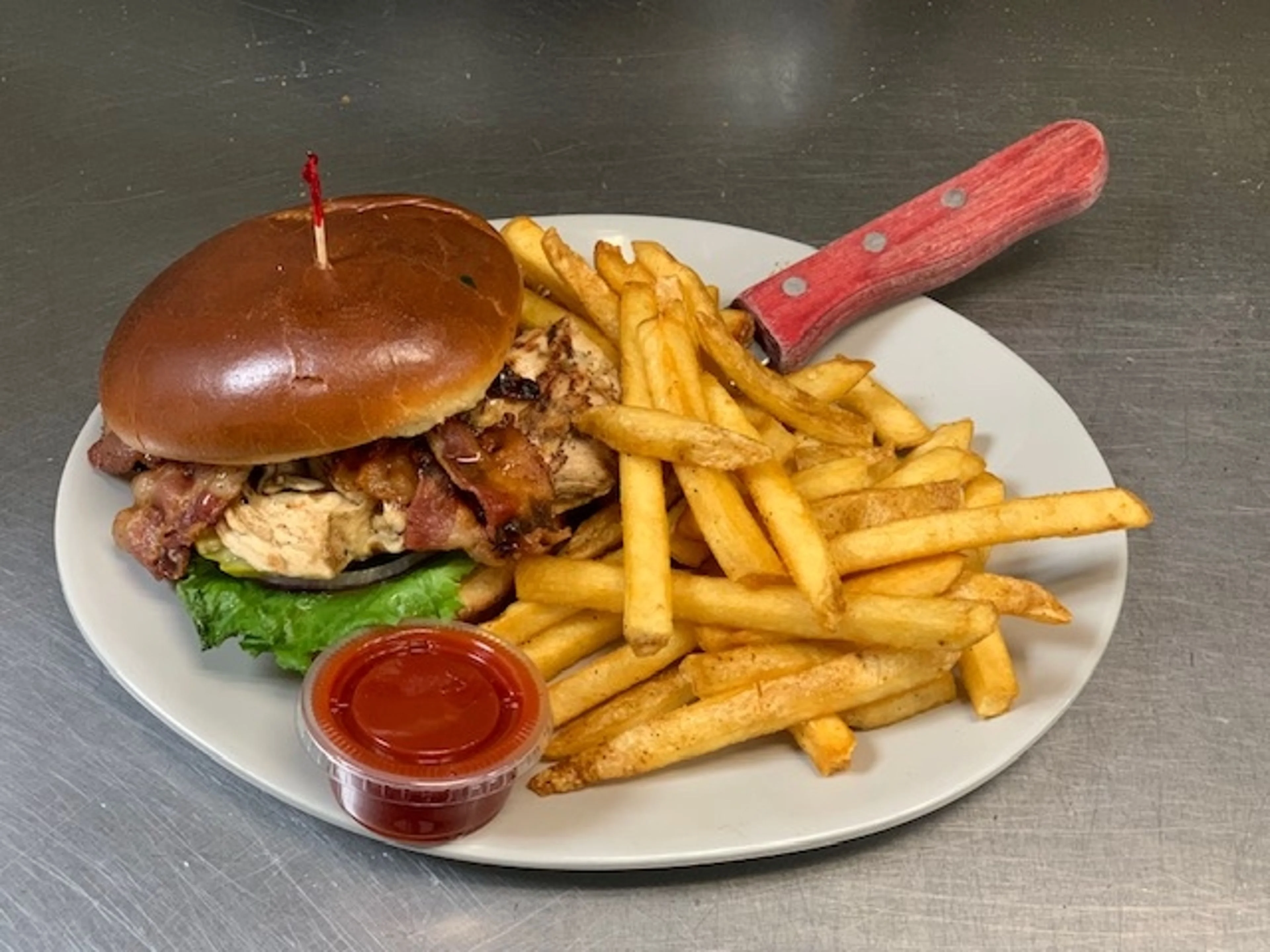 A side of fries paired with a fully loaded burger