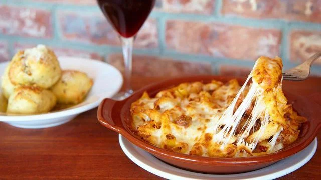 Cheese Being pulled from Baked Penne Bolognese