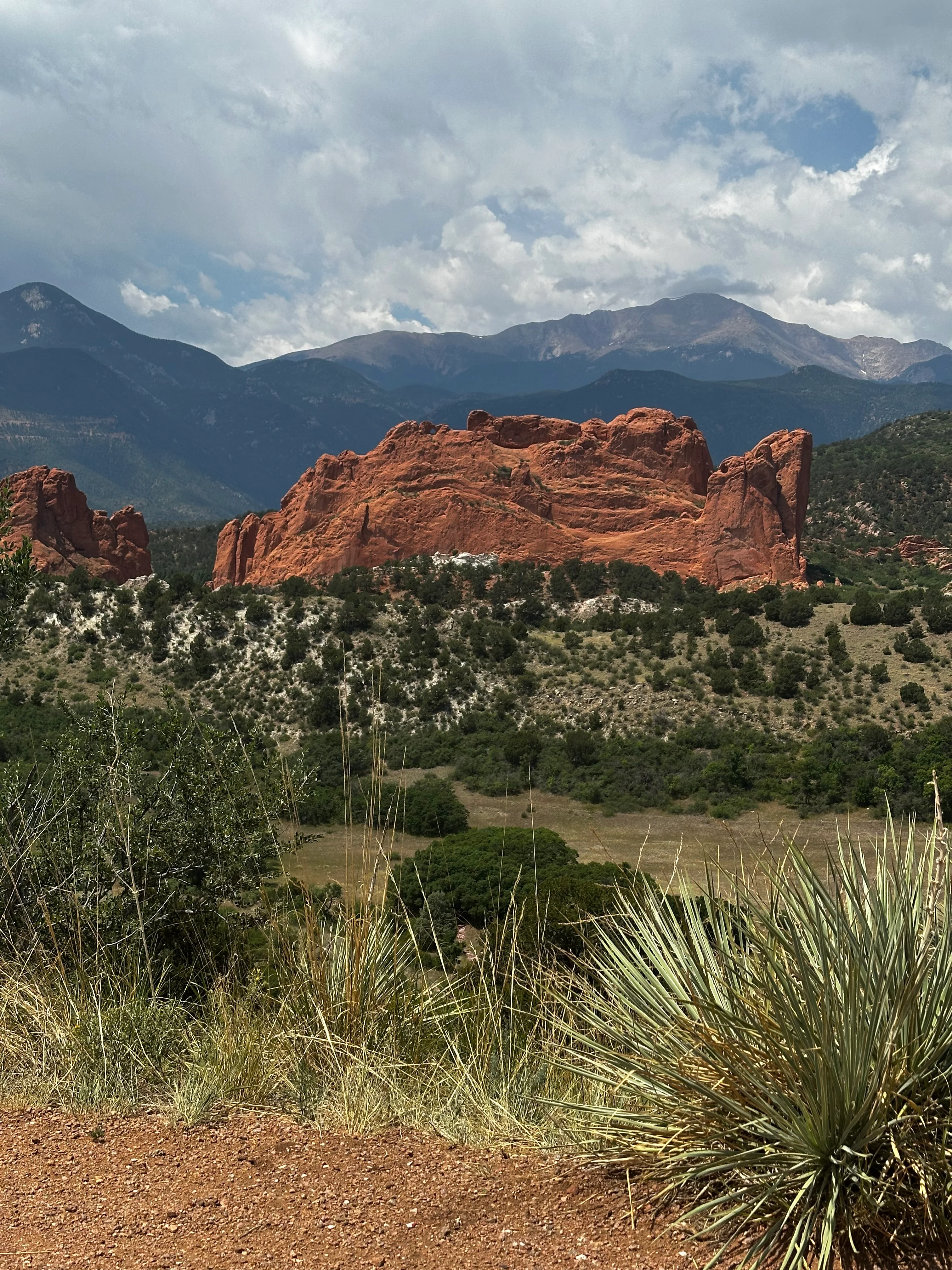 Scenic view of red rock formations against a mountain backdrop
