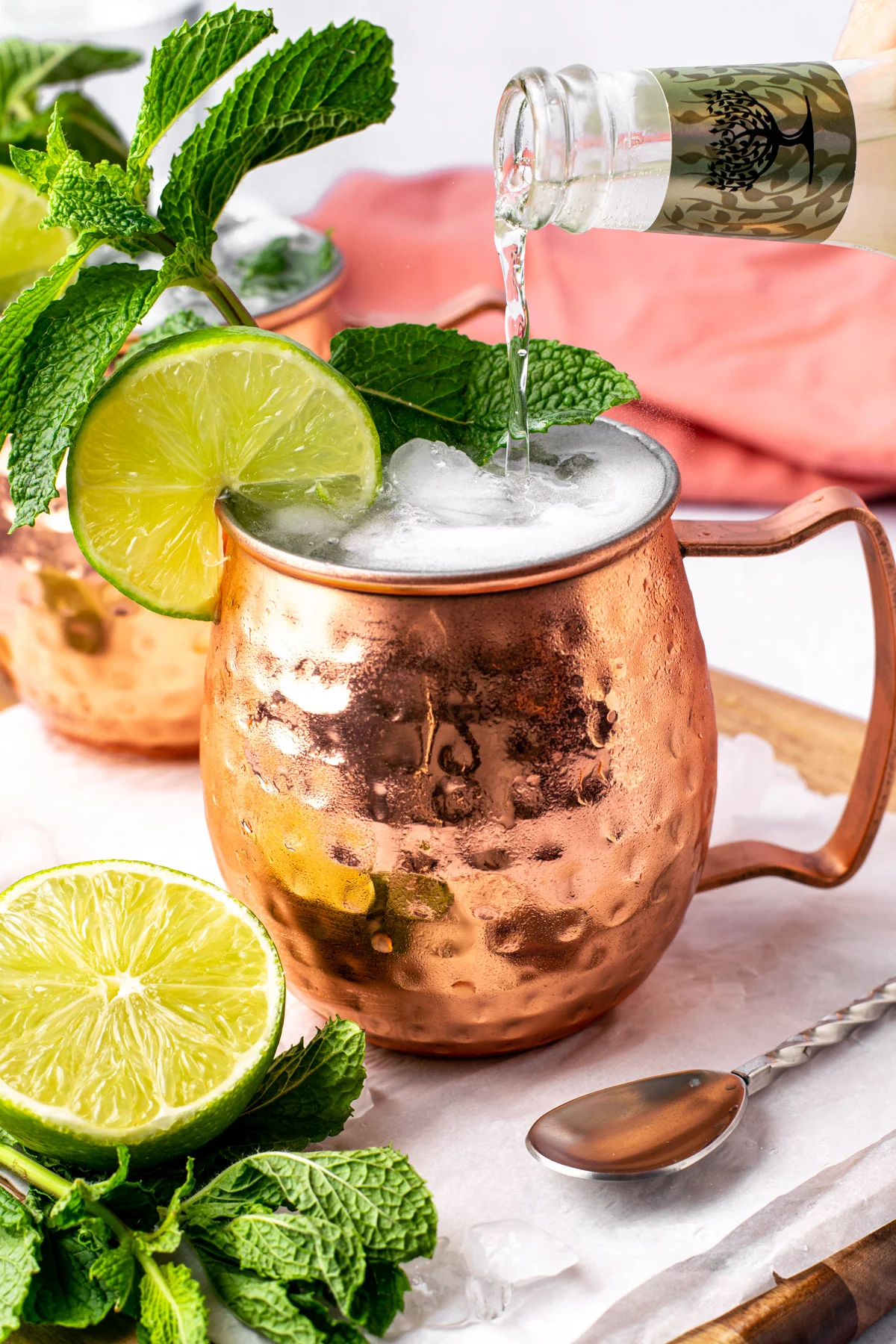 Refreshing Moscow mule in a copper mug with mint and lime