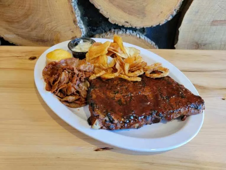 Barbecue ribs with sides in a rustic setting