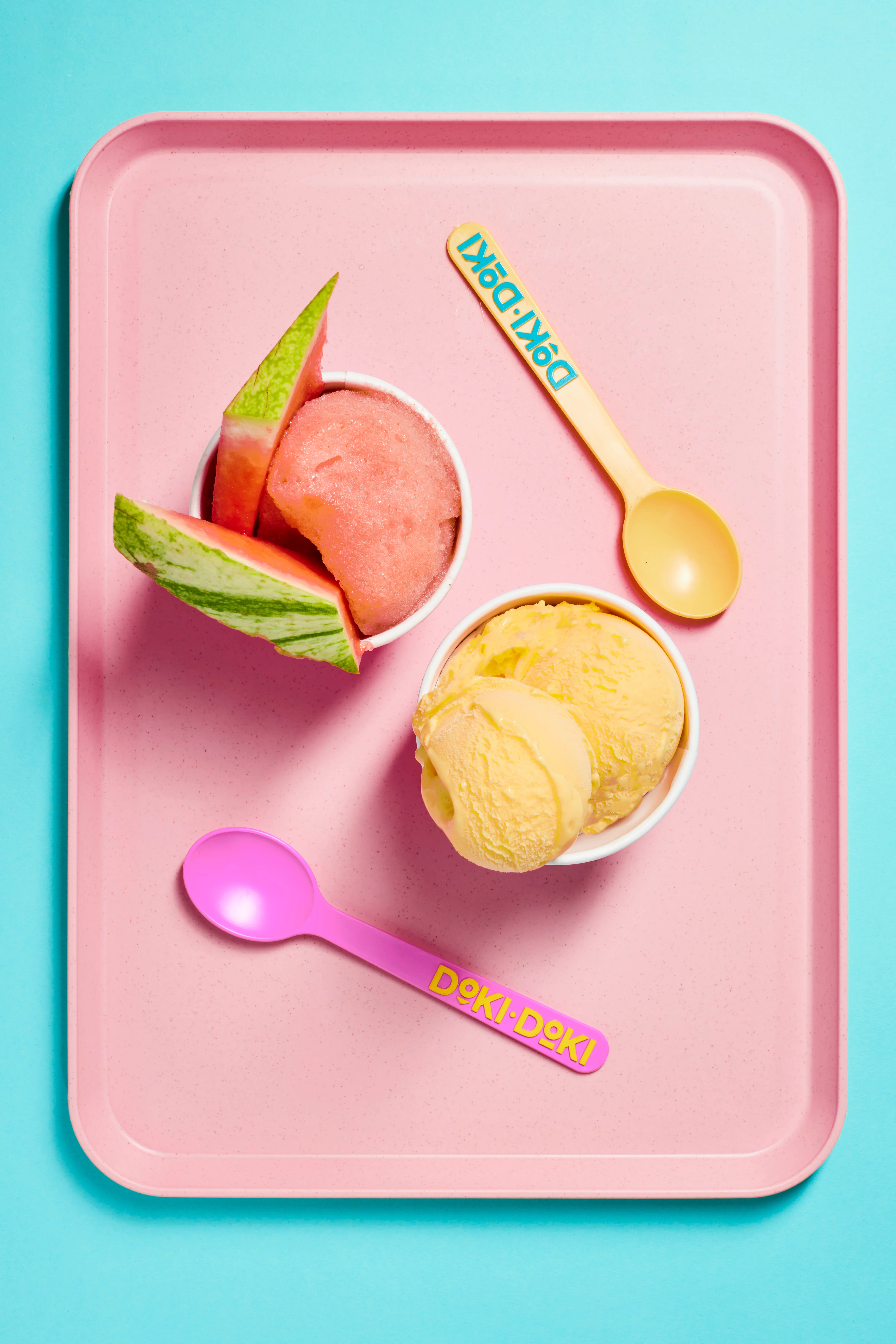 Refreshing watermelon sorbet and mango ice cream on a pink tray