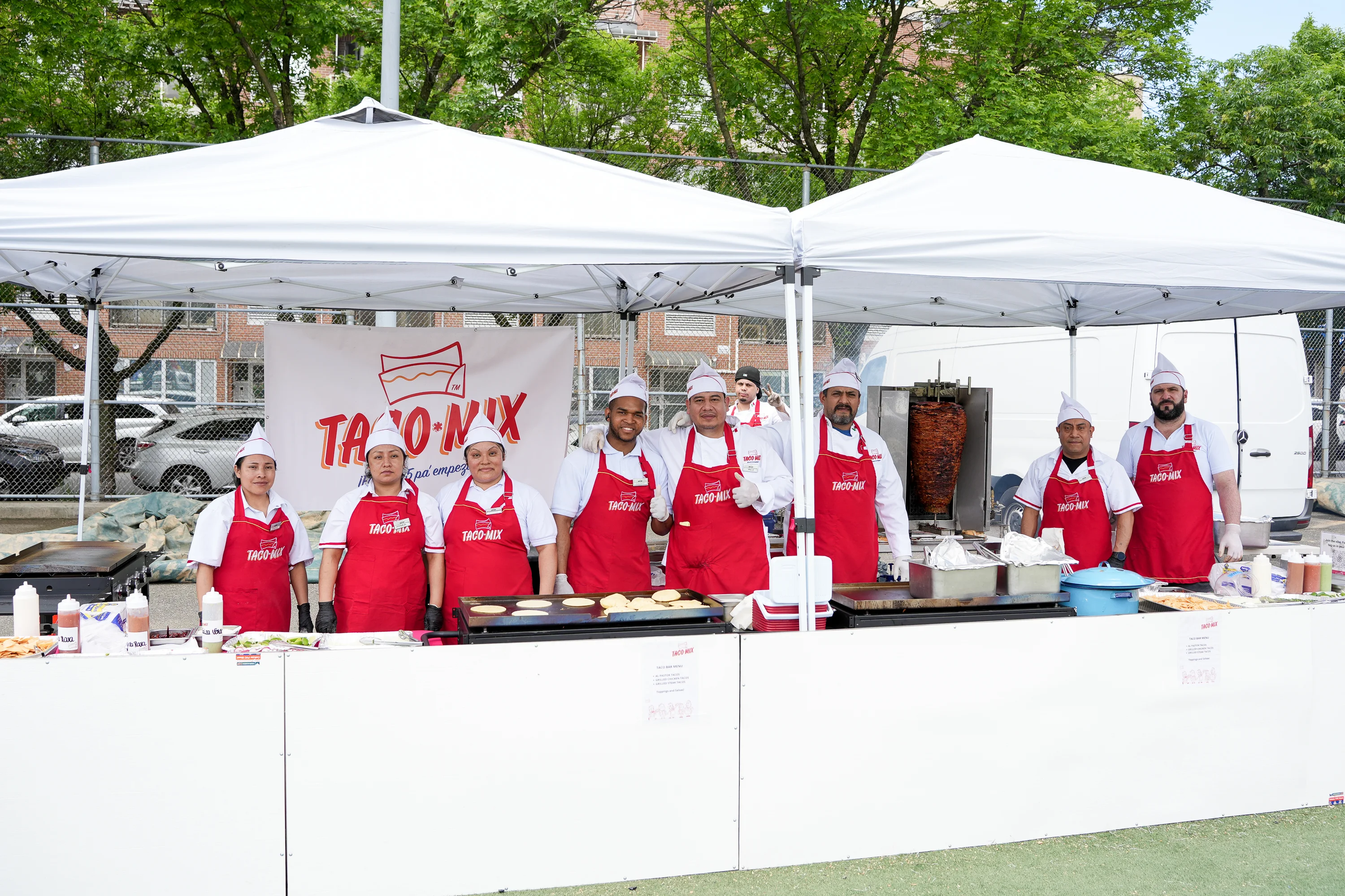 Taco stand with chefs preparing authentic Mexican tacos